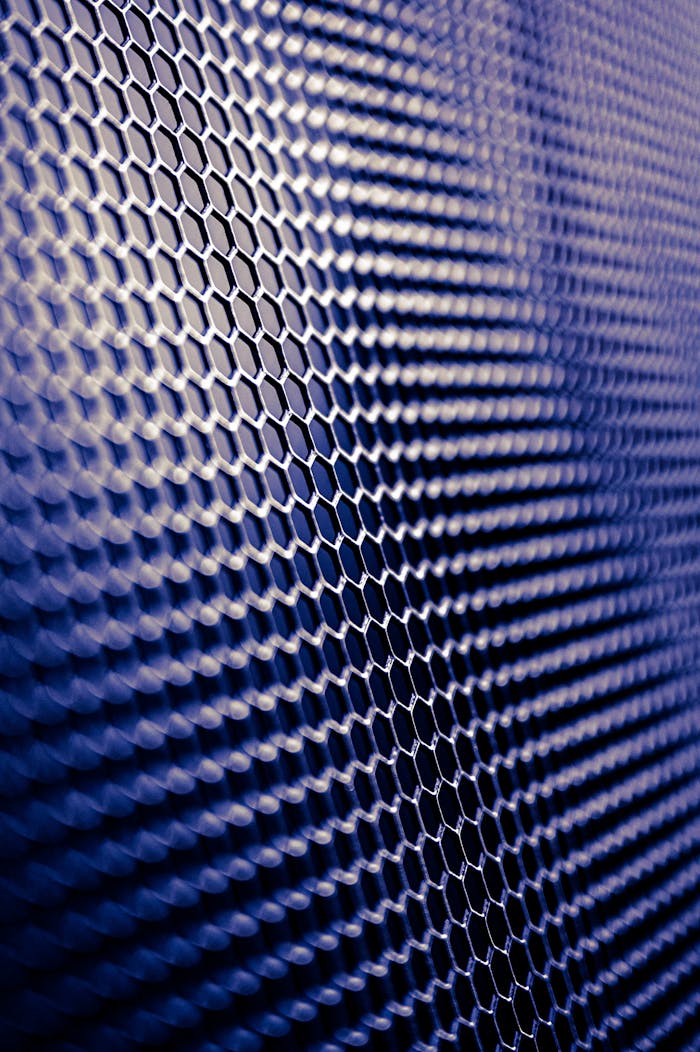why-choose-us-01 Close-up of a futuristic metallic hexagonal pattern, perfect for tech designs.